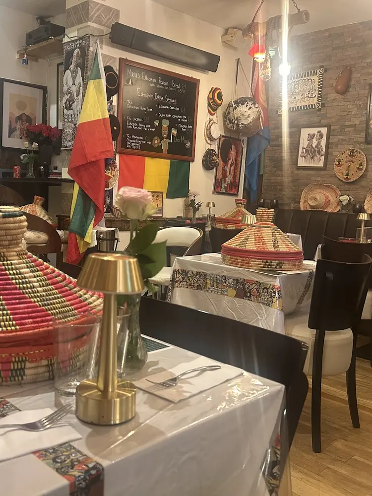 Dining room with mesob baskets on tables, Ethiopian flags and artwork