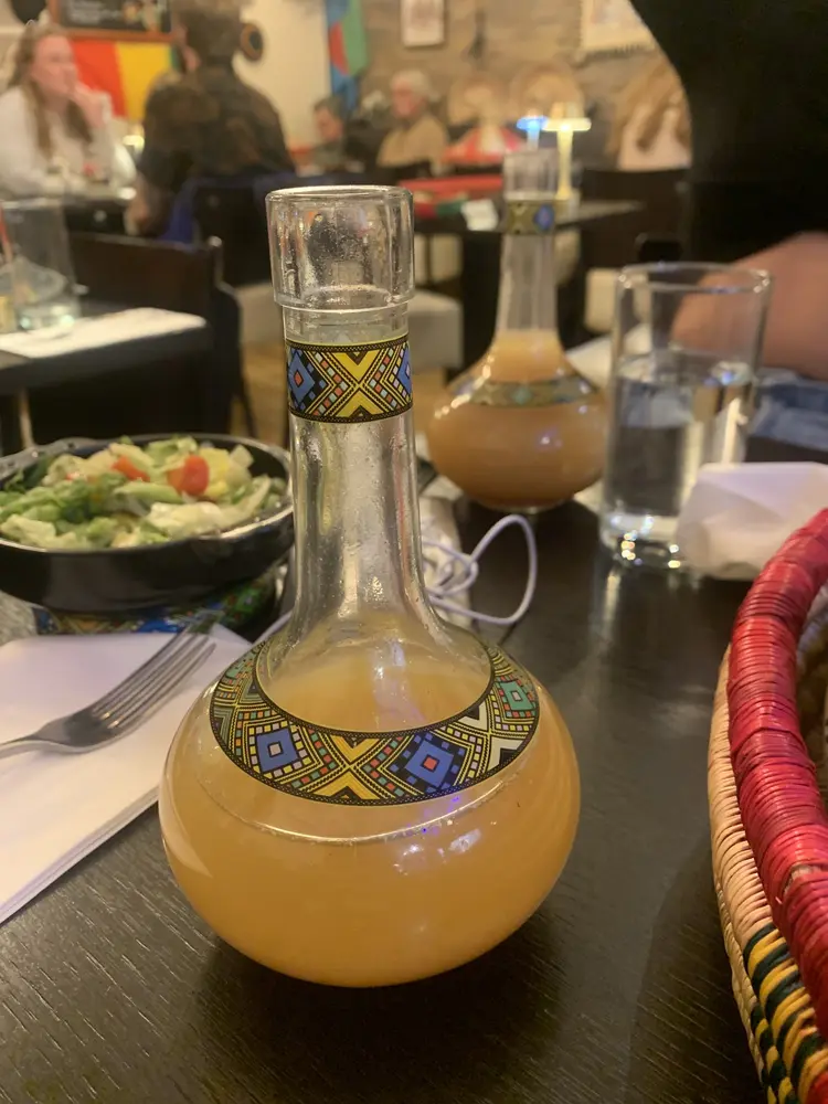 Tej honey wine served in a traditional round berele flask