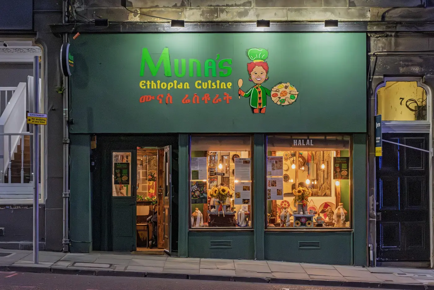 Muna's Ethiopian Cuisine glowing green shopfront at night, Gillespie Place, Edinburgh